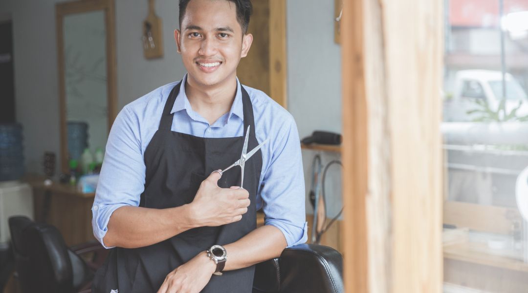 barber holding a pair of scissors